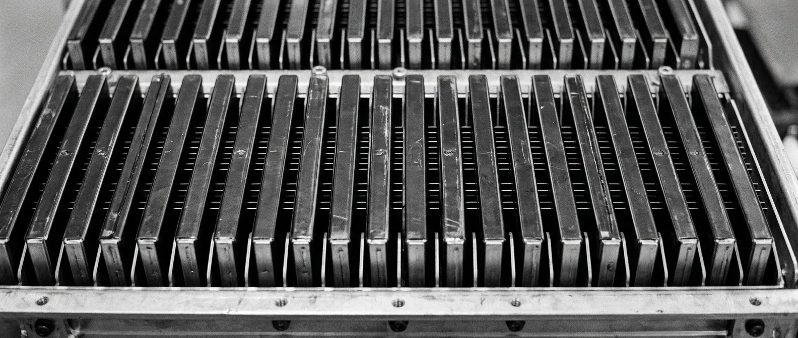 Close-up of long flat prismatic battery cells in a pack tray