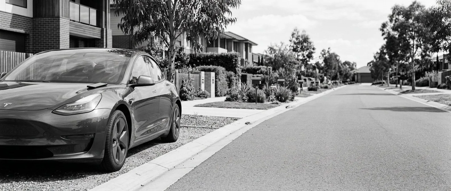 Electric car parked at the kerb of a quiet residential street