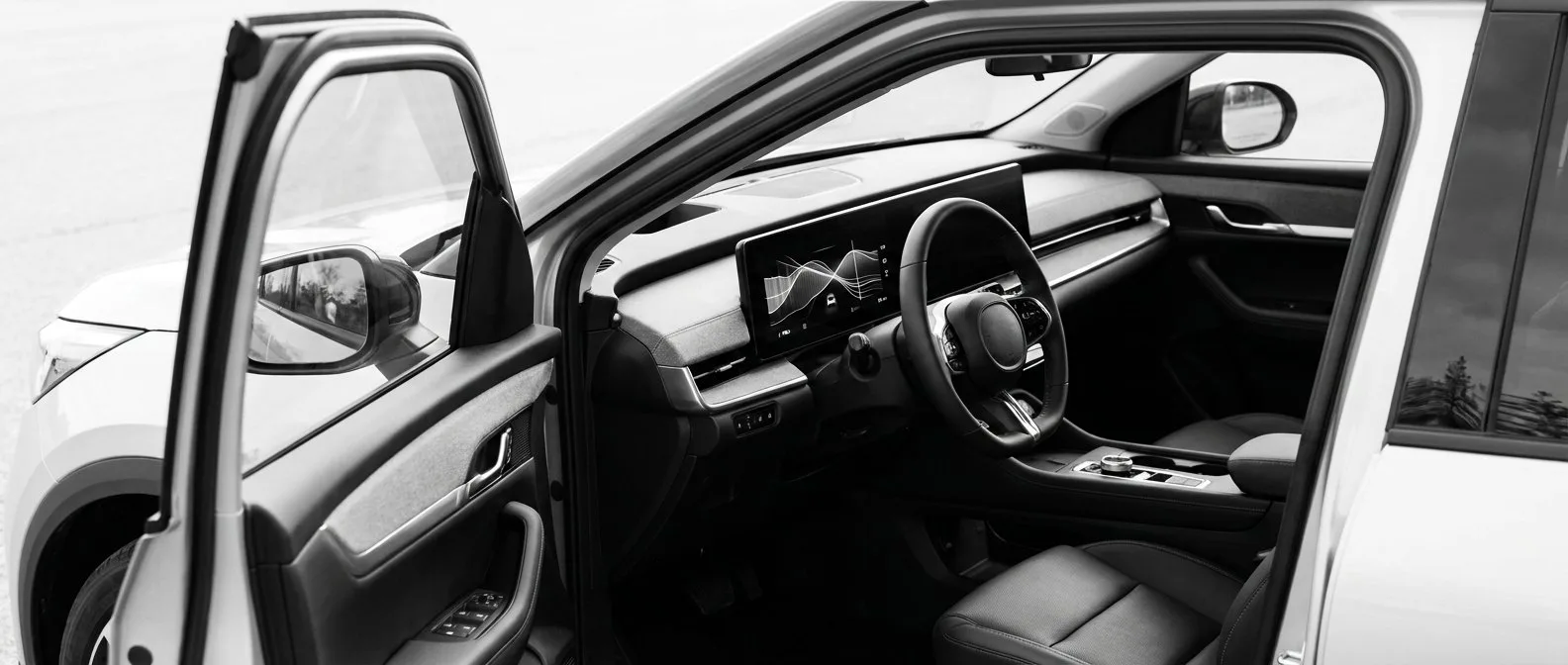 Dashboard display of a modern electric car showing a battery range graph
