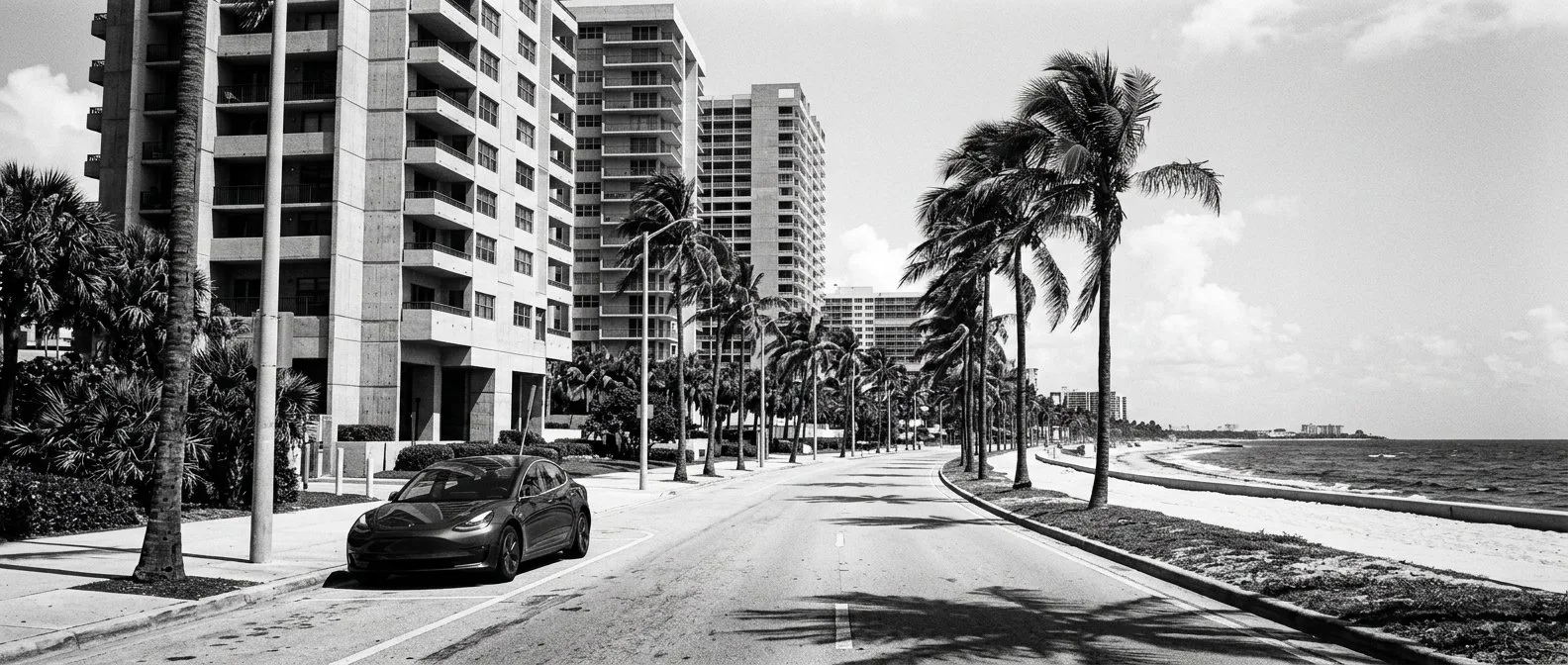 Electric car parked below high-rise towers on the Gold Coast