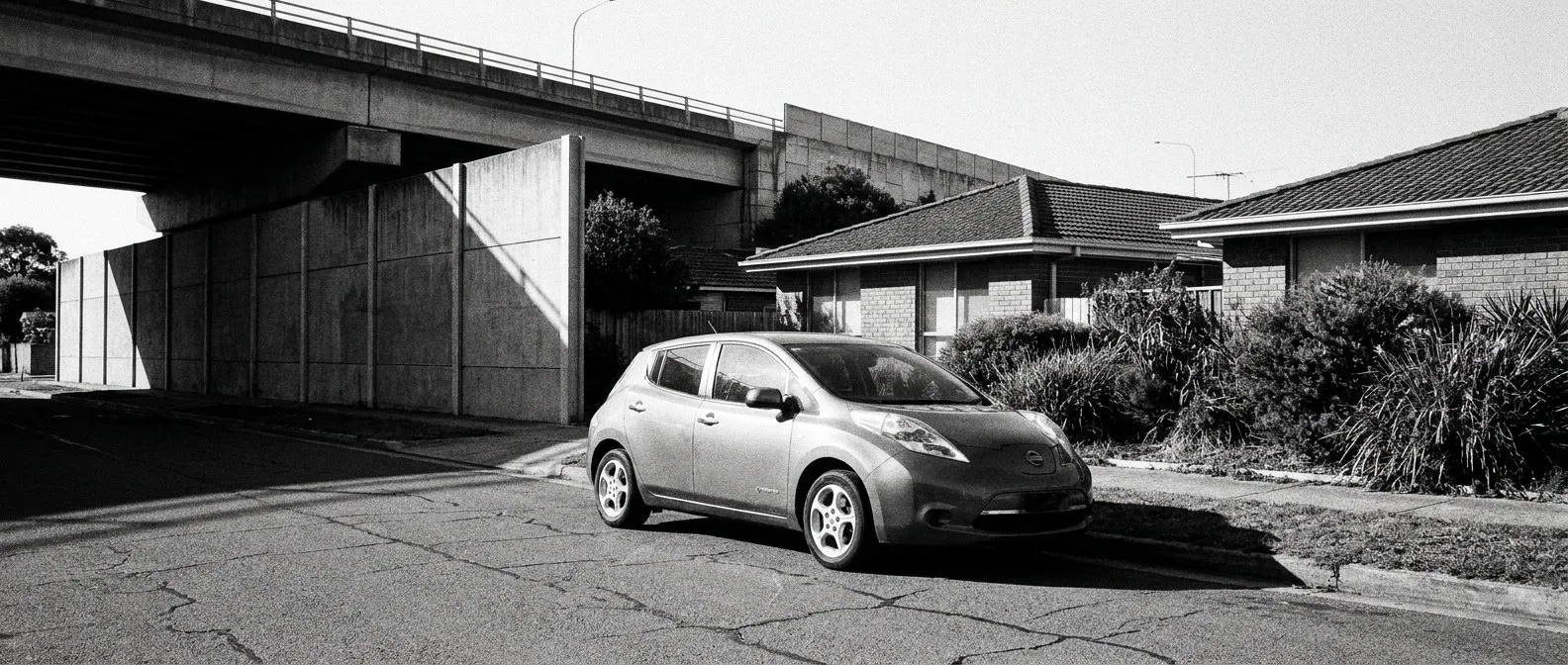 Electric car on a Logan street beside the motorway corridor