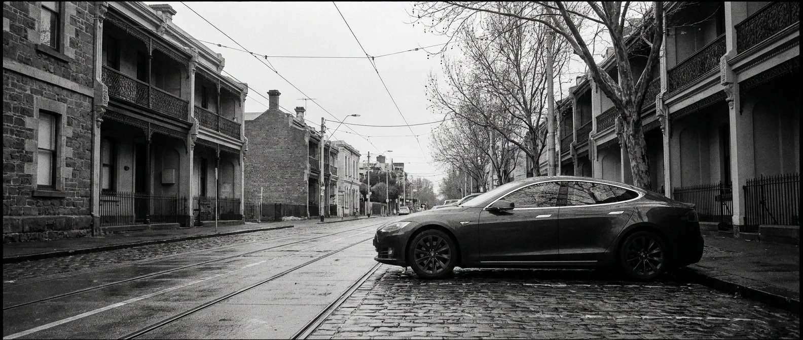 Electric car on a Melbourne street with tram tracks overhead