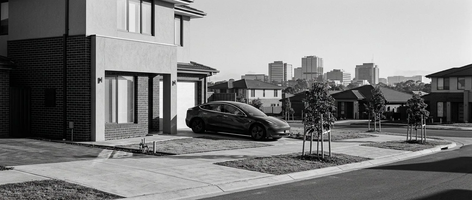 Electric car in the driveway of a new estate home near Parramatta
