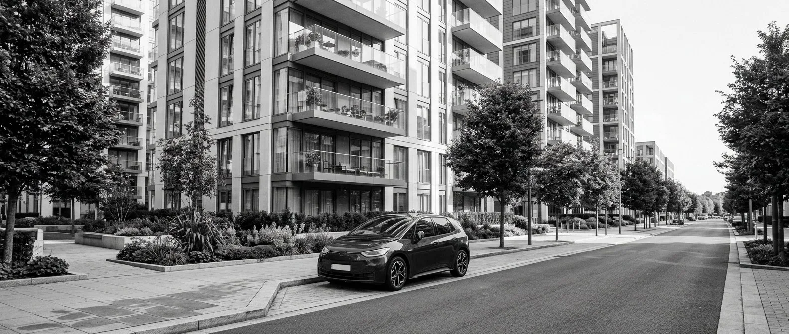 Electric car parked below apartment towers in the St George area