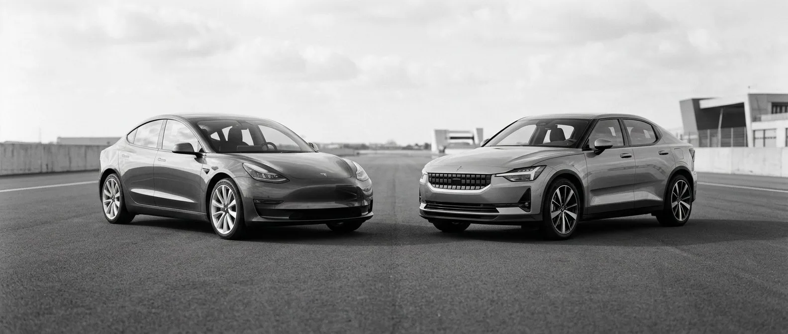 Two modern electric cars parked side by side for comparison